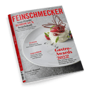 Titelbild der Zeitschrift „Feinschmecker“ mit roter Schrift auf grauem Hintergrund; mittig ein dekoriertes Dessert mit Himbeeren, Blattdekor und Schoko-Ornament auf weißem Teller, daneben Texte wie „Gastro-Awards 2025!“, „Elsass – Weinreise zu Newcomern und Stars“ und „Angeschärft – Curry-Gerichte mit Fleisch, Fisch und Gemüse“, am linken Rand roter Buchrücken mit weißer Aufschrift „50 Jahre Feinschmecker“.