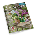 Titelbild der Zeitschrift „LandIDEE“ mit einem sommerlich dekorierten Holztisch auf einer Wiese, darauf ein grüner Krug mit lila und weißen Fliederblüten, Ton- und Zinktöpfe sowie lose Blüten; oben stehender Text: „284 Ideen für sonnige Tage“, weitere sichtbare Schlagzeilen zu Rezepten mit Erbsen, kugelförmigen Blüten im Beet, Erdbeeren und Gesundheit.