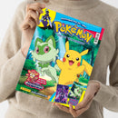 Helles, farbiges Magazin mit dem Titel „Pokémon – Das offizielle Magazin“, in beiden Händen einer Person mit beigefarbenem Strickpullover gehalten; das Cover zeigt zwei gezeichnete Pokémon-Figuren, Pikachu in Gelb und Felori in Grün, vor einem Waldhintergrund, oben blaue Schrift „schnapp sie dir alle!“, unten Logos „Panini“, „Paradoxrift“, Webadresse „www.pokemon.de“ sowie Hinweise auf Poster und Spielzeug.