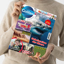 Helle, langärmlig bekleidete Person hält eine Ausgabe des Magazins „Galileo Genial“. Titelbild zeigt einen großen weißen Hai unter Wasser mit der Überschrift „Geheimnisse der Meere“, dazu kleinere Abbildungen: ein durchleuchteter Hai mit „Extra: Hai-Anatomie“, eine Staubwolke mit „Sahara-Staub unter der Lupe“, ein tauchendes Kind mit „Entdecker der Unterwasserwelt“ sowie „Neandertaler vs. Homo Sapiens“ und „Knick in der Optik“.