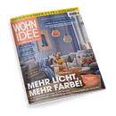 Titelbild der Wohnzeitschrift „Wohnen Idee“, Ausgabe Nr. 2 vom Februar 2025, mit einem Wohnzimmermotiv mit grauem Sofa, runder Holzcouchtisch mit buntem Deko-Arrangement, drei Hängelampen in Weiß, Grau und Orange, im Hintergrund Vorhänge und Wandbild; Haupttitel: „Mehr Licht, mehr Farbe!“ sowie weitere Texte wie „Großer Wohnzimmer-Guide“, „Ran ans Regal“, „Ladylike vs. Männersache“ und „Wohlfühl-Essen – von wärmenden Suppen bis Orange-Couscous“.