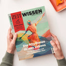 Person hält das Magazin „ZEIT Wissen“ mit hellgrünem Titelblatt; darauf eine abstrakte, mehrfarbige Illustration einer tanzenden, menschlichen Figur in fließenden Formen aus Rot‑, Gelb‑, Blau‑ und Grüntönen. Texte auf dem Cover: „ZEIT WISSEN – Bringt Sie auf gute Gedanken“, „Besser wohnen – Inspirationen aus Japan für ein schöneres Zuhause“ und „Der Rhythmus deines Lebens – Wie du ihn findest und dich von ihm tragen lässt“.