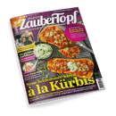 Titelbild der Kochzeitschrift „mein Zaubertopf“ Ausgabe 6/2024 mit dem Schwerpunkt „Neue Schlemmer-Ideen à la Kürbis“ vor schwarzem Hintergrund; mittig ein Teller mit vier gefüllten Kürbishälften neben einer Schale mit grünem Dip, oben links kleiner runder Aufdruck „Easy in den Feierabend“, unten große gelbe Überschrift, links ein Bild von einer lächelnden Frau mit Thermomix, rechts Strichcode, oben lila Farbfläche mit weißer Schrift.