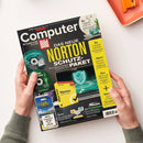 Titelbild der Zeitschrift „Computer Bild“, Ausgabe 11/2025, mit Schwerpunkt „Das neue Norton Schutz-Paket“. Abgebildet sind eine Laptop-Grafik mit leuchtendem Schutzschild-Symbol, zwei DVDs und eine gelb-schwarze Norton-Software-Verpackung. Gelb hinterlegte Textkästen rechts mit Themen wie Bluetooth-Lautsprecher, Gratis-Fotoprogramme und KI-App. Gehalten von zwei Händen vor hellem Hintergrund.