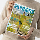 Titelseite der Zeitschrift „Runner’s World“ mit blau-weißem Logo im oberen Bereich, gehalten von einer Person in beigefarbenem Strickpullover. Auf dem Cover läuft eine männliche Person mit gelbem T‑Shirt, blauer Shorts und Sonnenbrille auf einem sonnenbeschienenen Bergpfad. Sichtbare Überschriften: „Das Geheimnis der Superschuhe“, „Die Wunderläuferin“, „Warum bin ich nicht schneller?“, „So schläfst du besser – ein Leitfaden“ und „Es gibt kein Alterslimit“.