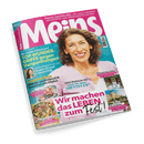 Titelbild der Zeitschrift „Meins“ mit einer älteren, lächelnden Frau mit lockigem braunem Haar in rosa Bluse vor türkisfarbenem Hintergrund; zentrale Schlagzeilen u. a.: „TOP-WUNDERGRIFFE gegen Verspannungen“, „Wir machen das LEBEN zum Fest!“, „Zeit für neue ABENTEUER“, „Welche wir WIRKLICH brauchen mit 50plus“, „Leichte Sommergerichte“, „Wien, du Schöne…“.