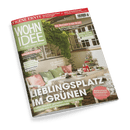 Titelbild der Zeitschrift „Wohnidee“ Ausgabe Nr. 6 vom Juni 2025, zentral dominiert von einem hell gedeckten Gartentisch mit weißem Netz-Tischtuch, roten Gläsern, weißen Teelichtern und grüner Deko, umgeben von Sitzmöbeln mit rosa und grünen Kissen; im Hintergrund Fensterfront mit üppiger Rankpflanze. Hauptüberschrift: „Lieblingsplatz im Grünen“. Weitere Textelemente thematisieren DIY-Ideen, Gartengestaltung, Schlafberatung und Erdbeerrezepte.