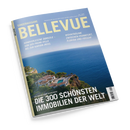 Schräg fotografiertes Magazincover der Sonderausgabe „BELLEVUE“ in Blau und Gelb. Das Titelbild zeigt eine Küstenvilla mit Pool, grüner Vegetation und blauem Meer; sichtbare Texte: „Handverlesene Domizile – von der Promi-Villa bis zur Karibik-Insel“, „Wohnträume zwischen Frankfurt, Florida und Fidschi“ und „Die 300 schönsten Immobilien der Welt“.