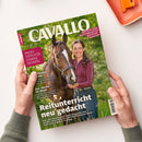 Aufgeschlagen gehaltenes CAVALLO-Magazin mit braunem Pferd und weiblicher Person im burgunderroten Oberteil auf grünem Hintergrund. Sichtbare Texte: „CAVALLO“, „Deutschlands meistverkauftes Reitsport-Magazin“, „Profi-Tipps für starke Sehnen“, „Reitunterricht neu gedacht“ und „Das steckt im Mash“; das Heft liegt über einer weißen Fläche, oben rechts ist ein orangefarbenes Objekt erkennbar.