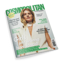 Schräg fotografiertes, glänzendes Magazin „COSMOPOLITAN“ auf schwarzem Hintergrund. Das Cover zeigt eine blonde weibliche Person in weißer ärmelloser Kleidung; lesbare Texte sind „FUN. FEARLESS. FEMALE.“, „THE MONEY ISSUE“, „Charis-ma? Charis-me!“, „Meghan Fahy“, „FULL FACE LOOKS“ und „Girls just wanna have funds!“.