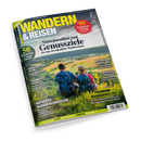 Titelbild des Magazins „Wandern & Reisen“ Ausgabe 03–26 Sommer. Vorderseite mit zwei wandernden Personen – eine männlich gelesene, eine weiblich gelesene – mit blauen und roten Rucksäcken, auf einem grünen Hang mit Blick über Felder und ein Tal. Überschriften: „Naturparadiese und Genussziele“, „Ratgeber: Blasen verhindern“, „Premium-Wanderwelten“, sowie Hinweise zu Süddeutschland, Alpenzielen, Langschleifen und Streifzügen.