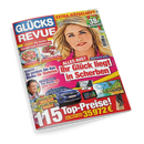 Titelblatt der Zeitschrift „Glücks Revue“ mit rotem und blauem Schriftzug, großem Porträt einer lächelnden blonden Frau vor hellem Hintergrund, mehreren kleineren Bildern darunter – u. a. ein Auto, elektronische Geräte, Urlaubsmotive und Speisen. Sichtbare Überschriften: „Ihr Glück liegt in Scherben“, „So senken Sie das Risiko für Diabetes“, „115 Top-Preise“ und „Leckere Rezepte zum Schlemmen“.