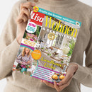 Eine weibliche Person im beigefarbenen Strickpullover hält eine schräg fotografierte Zeitschrift vor dem Oberkörper. Lesbar sind „Lisa“, „Wohnen & Dekorieren“, „Kreativ den Sommer verlängern“, „Landhaus-Liebe“ und „EXTRA: 60 Ideen für ein leichtes Wohngefühl“; das Cover zeigt ein hell eingerichtetes Esszimmer, Blumen und eine Frau mit Blumenstrauß.