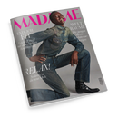 Schräg fotografiertes Cover der Zeitschrift „MADAME“ vor schwarzem Hintergrund mit einer lachenden männlichen Person in blauem Jeanshemd und Jeans, sitzend und mit ausgestrecktem Arm; dazu schwarze Stiefeletten. Sichtbare Texte: „ENDLICH FIT“, „Leicht & straff mit dem richtigen Krafttraining“, „WELT RÄUME“, „Die jungen Meister des Interior-Designs“ und „RELAX. So lässig ist die neue Mode“.